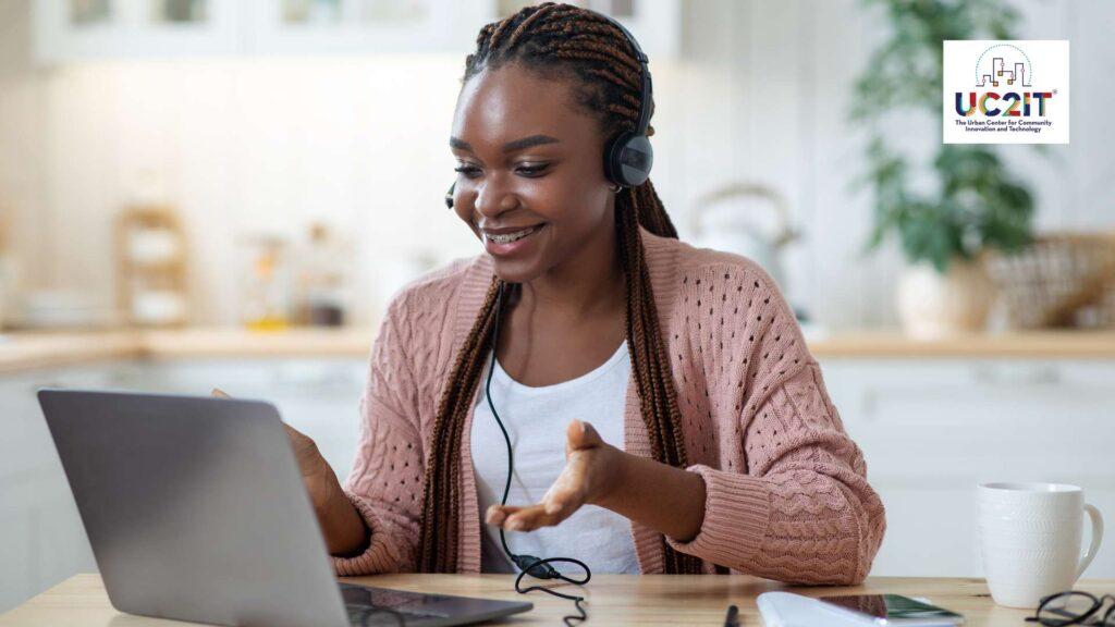 Woman with headset video conferencing at home.