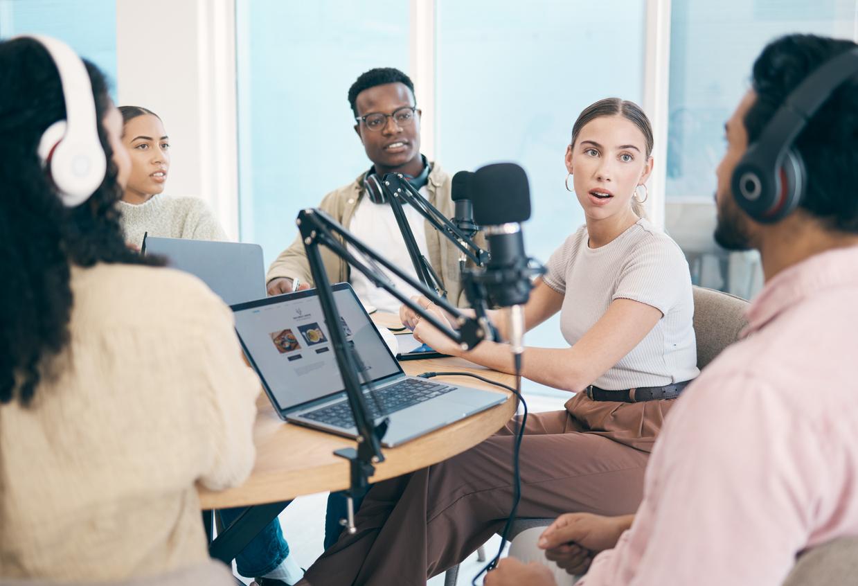 A photo of young people talking during a podcast